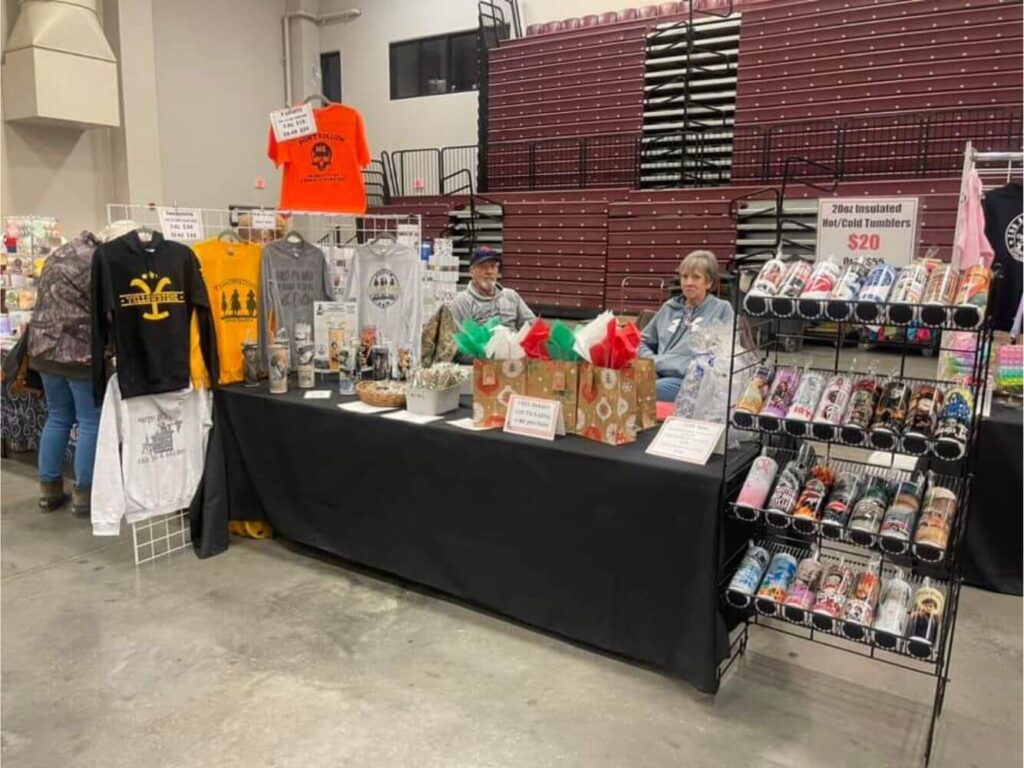 Apparel and accessories vendor table at a MAC Shows event
