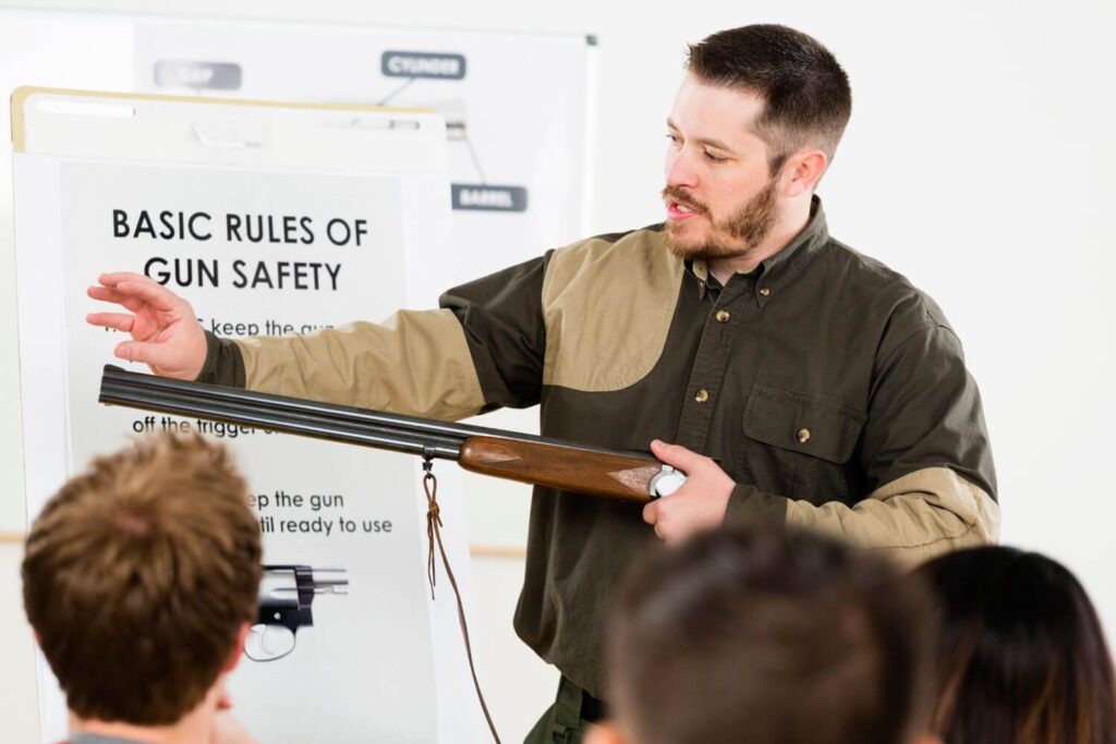 A trained professional conducting a course on the basic rules of gun safety