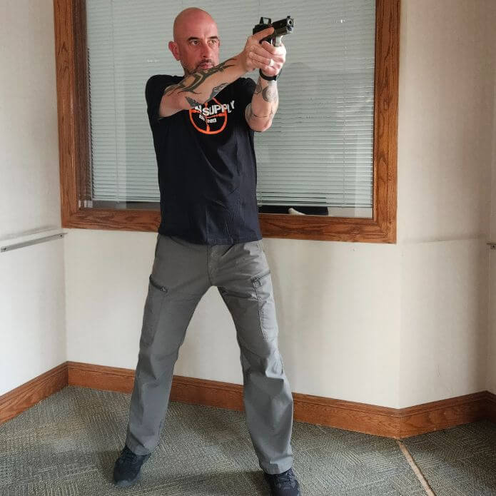 Man demonstrating weaver stance with a pistol