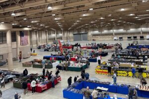 People walking around at an indoor gun show