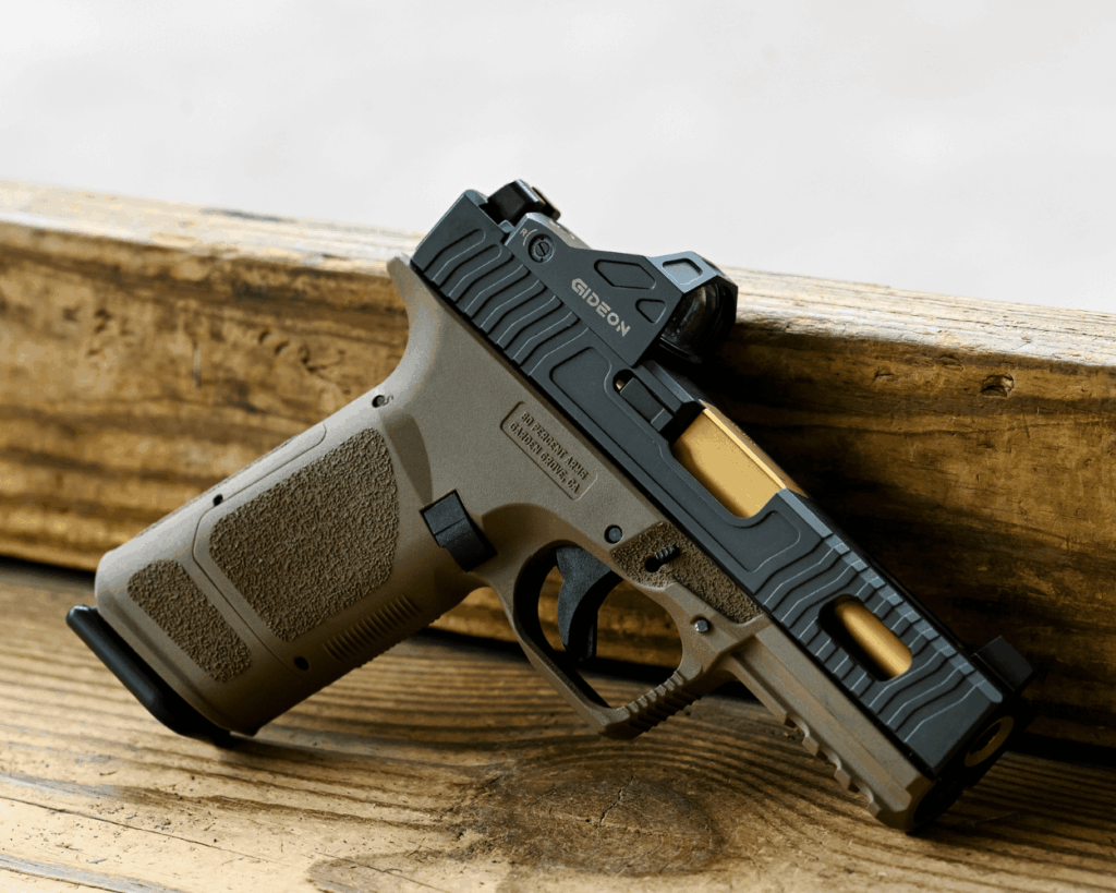 pistol with aftermarket parts installed laying against a wood table