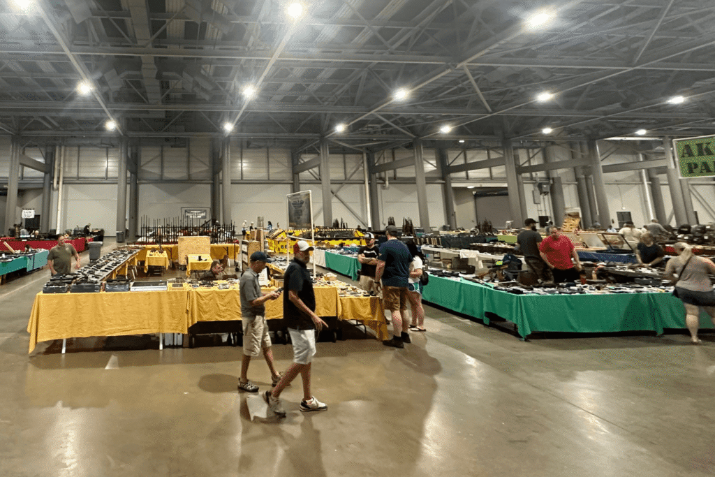wide view of shoppers browsing tables at a gun show