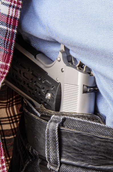Close up showing a pistol in an inside the waistband holster
