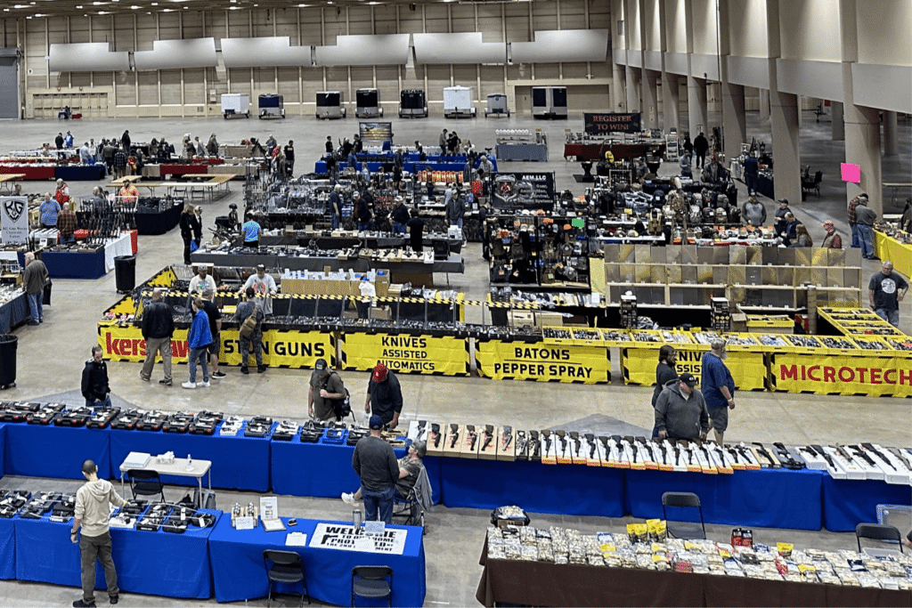 gun show attendees browsing vendor tables