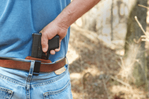 View of mans back with a waistband holster holding a pistol