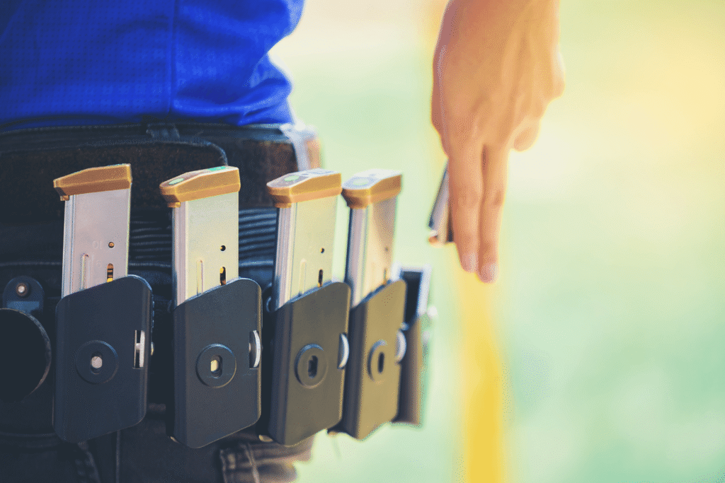 Woman wearing a belt with multiple magazines strapped to it