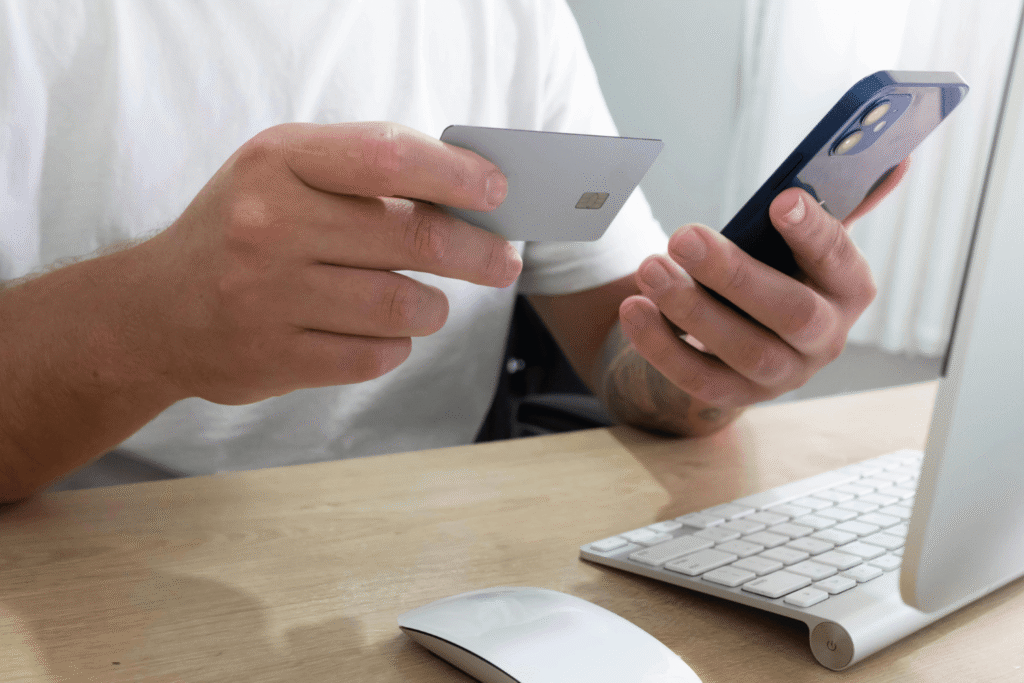 Person holding phone and credit card as they are online shopping
