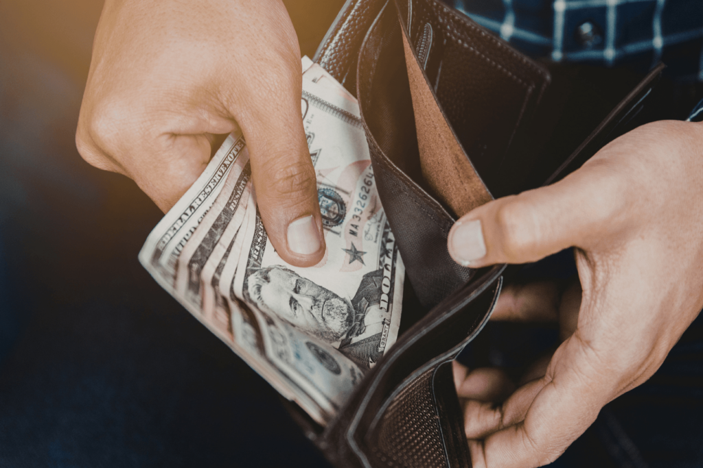 man pulling cash out of a wallet
