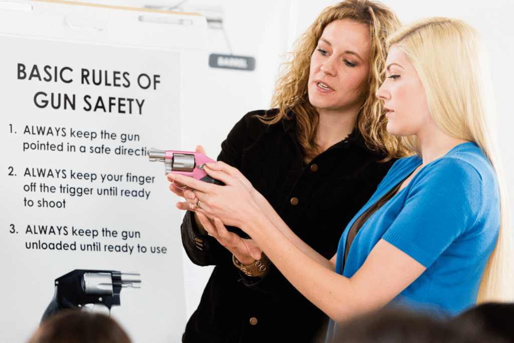 Woman learning gun safety from a professional firearms instructor